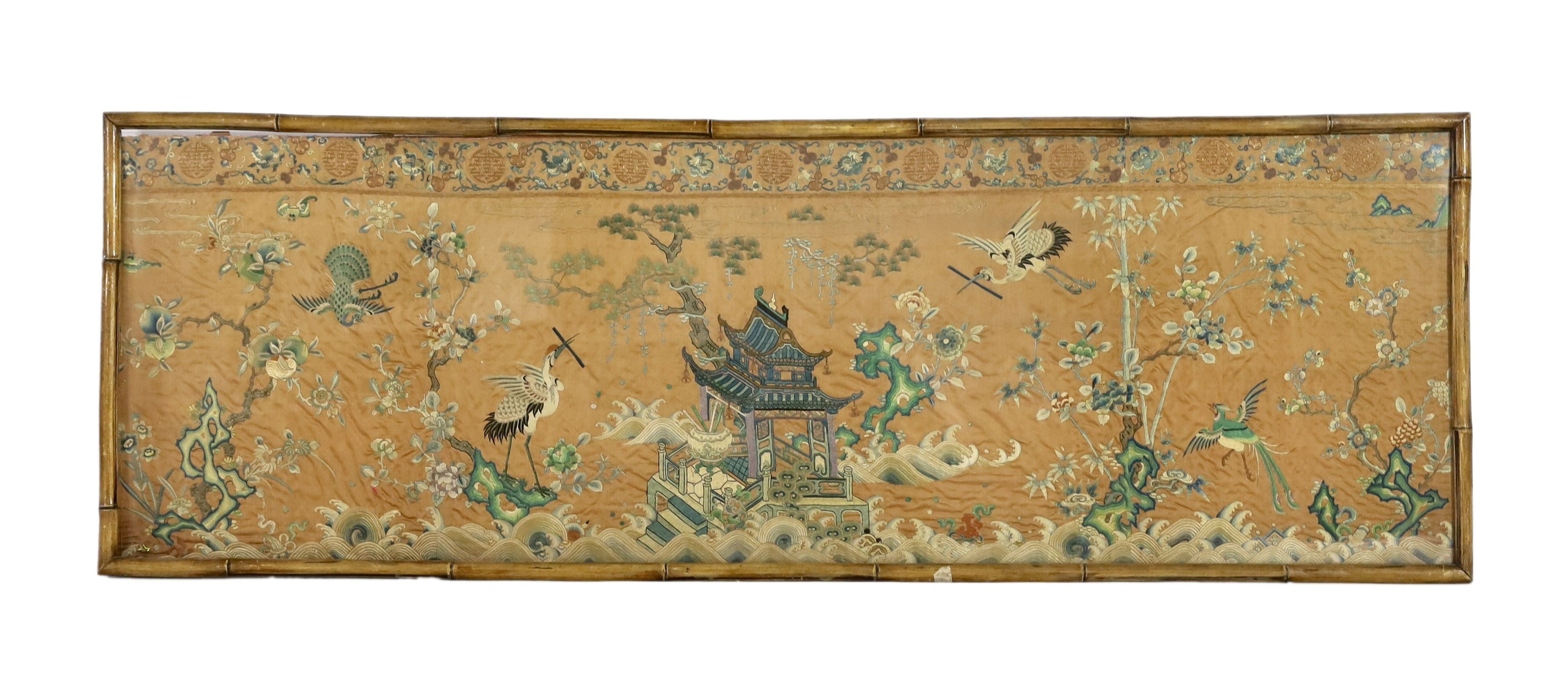 A Chinese apricot ground embroidered silk table frontal, late Qing dynasty, 58cm x 178cm, now trimmed and framed